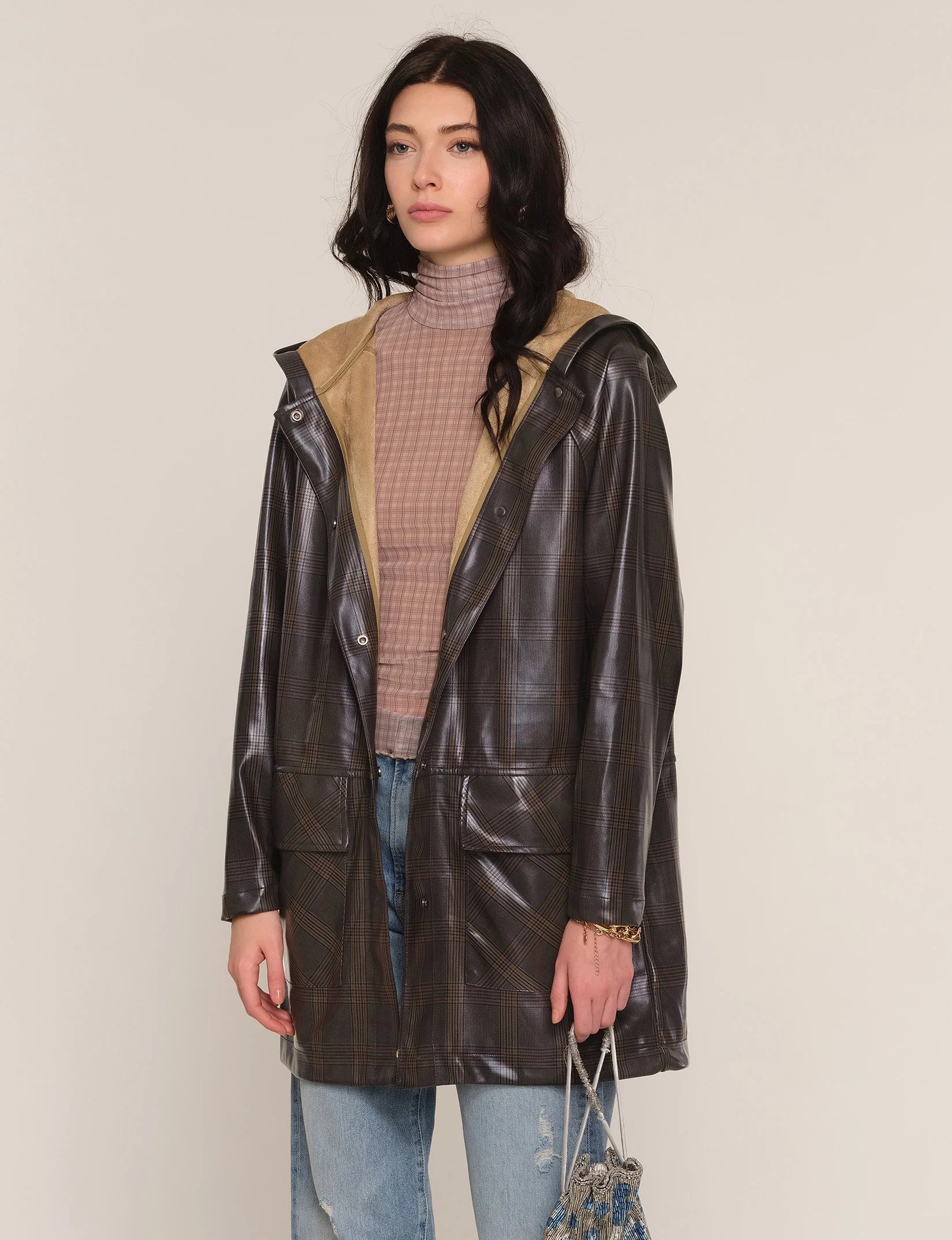 Model wearing the Heartloom Sergi Raincoat in dark plaid, front view.