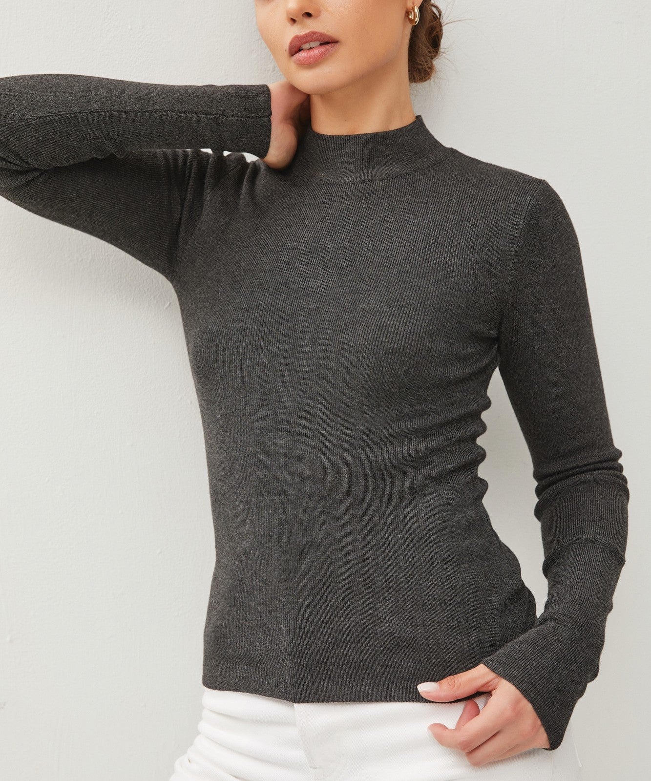 Moonbeam Long Sleeve Sweater Charcoal. This ribbed long sleeve sweater features a mock neckline and fitted design making it the perfect layering piece for everyday.