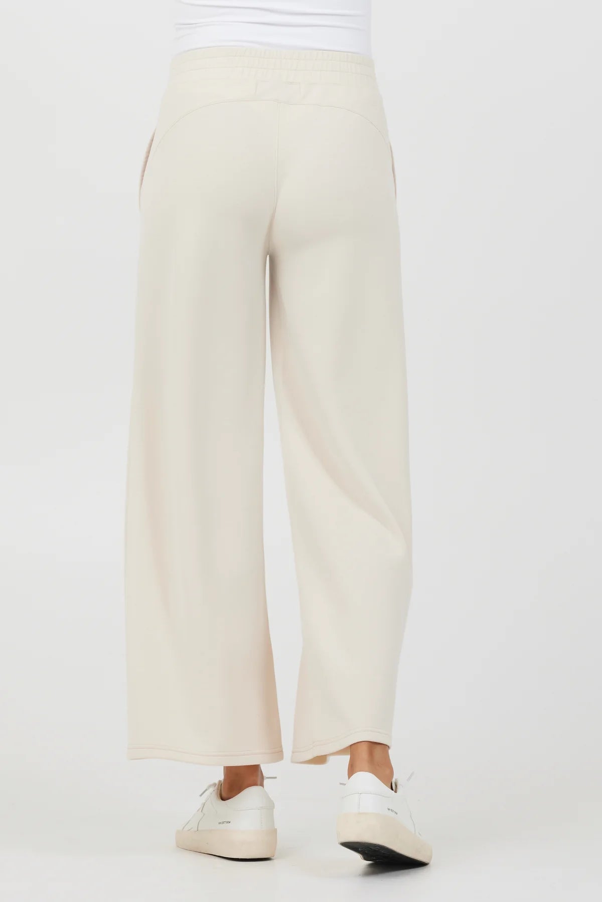 Vintage Havana Cloud Fleece Flare Pant Sand. These flare pant joggers come in the softest cloud fleece fabric and feature an elastic waistband with front pockets, perfect for hanging at home or on the go.