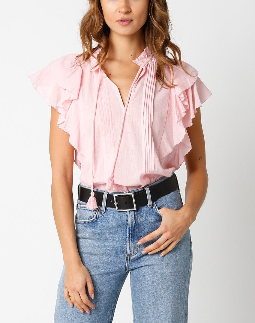 Jayla Ruffle Sleeve Blouse Light Pink. This ruffle sleeve blouse features a v-neckline with tassel bottom front ties, the perfect top to throw on with your favorite jeans for an easy put together look.