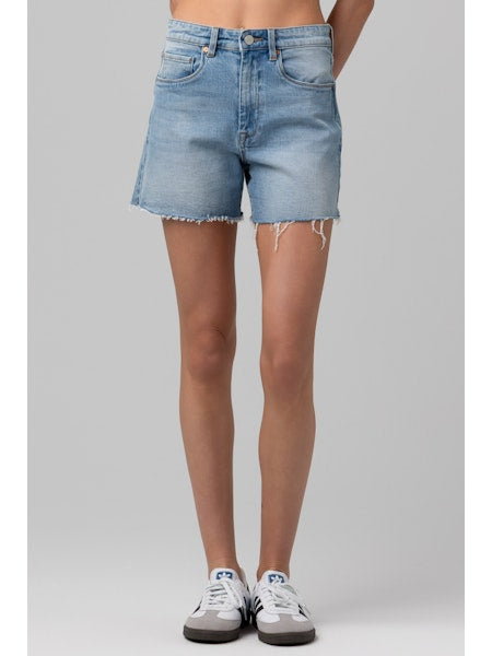 High-rise denim shorts with a longer length and raw hem styled with sneakers