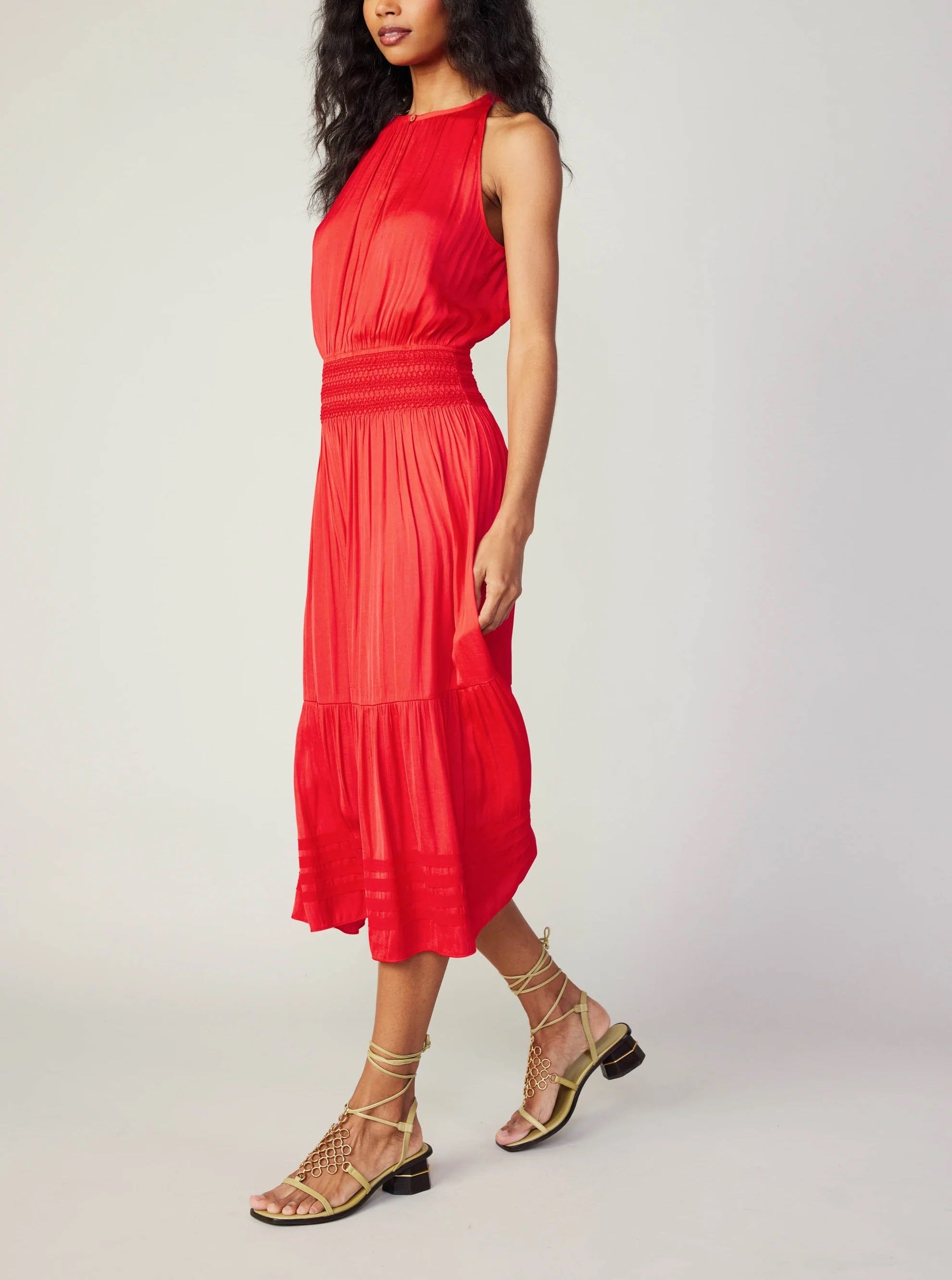 Current Air Halter Key Hole Midi Dress Bright Red. An effortless midi dress that's simple yet stunning. The sleeveless halter style is beautifully gathered at the bodice and smocked at the waist, complete with tonal embroidery. The skirt flows to a shin-skimming tiered hem encircled by tonal chiffon bias tape.
