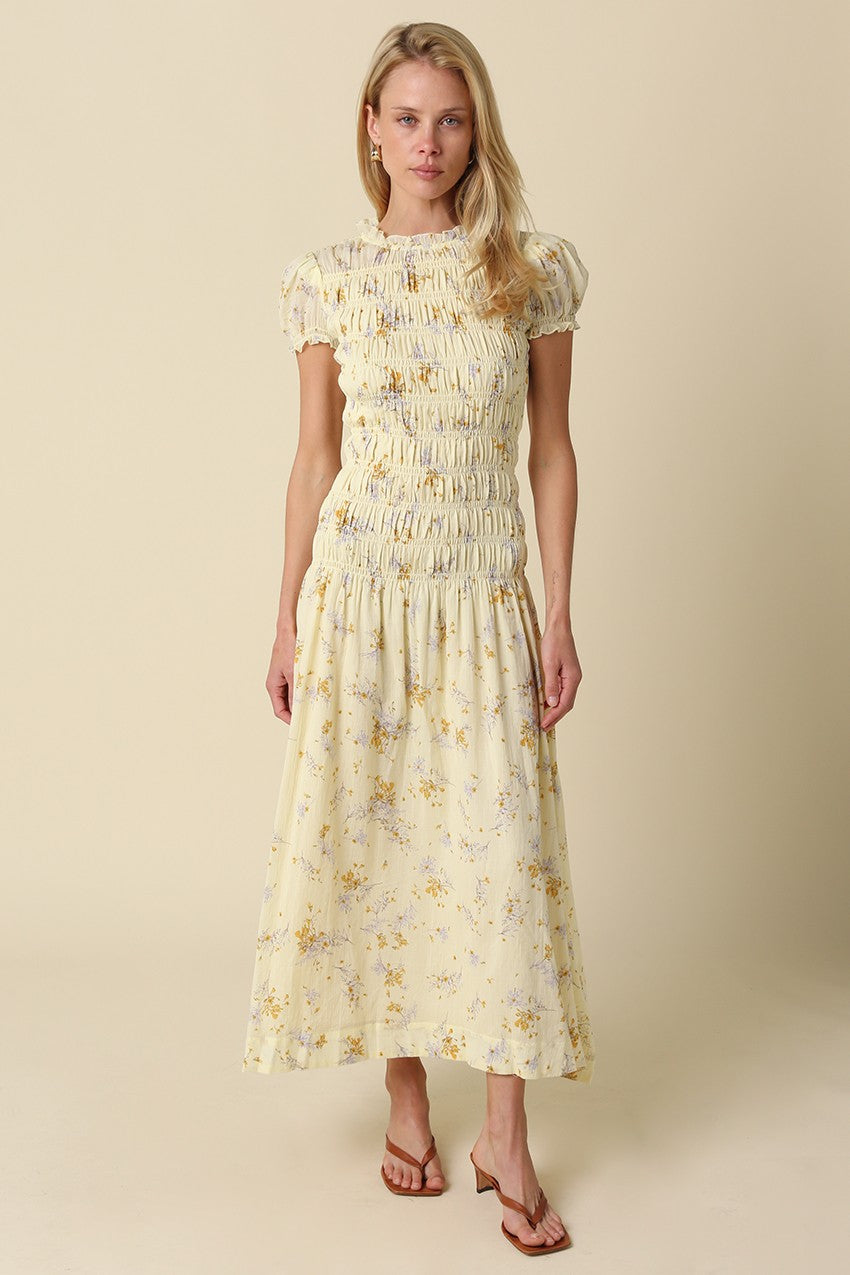 Floral midi dress with smocked bodice, puff sleeves, and flowy skirt styled with sandals