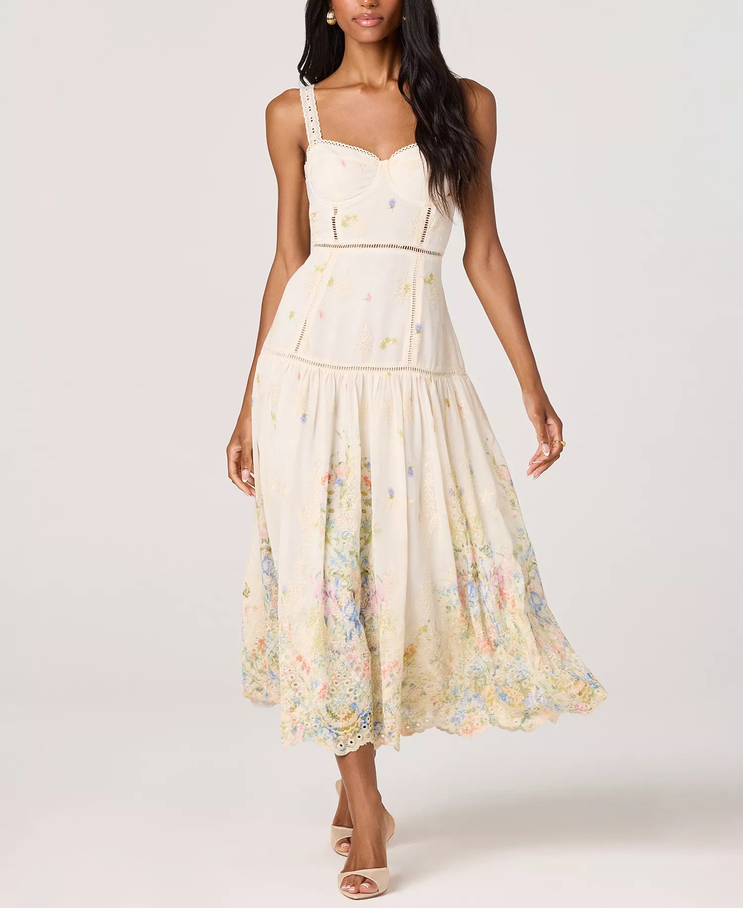 Woman wearing a floral midi dress with lace trim straps, a fitted bodice, and a flowy skirt with a soft floral print