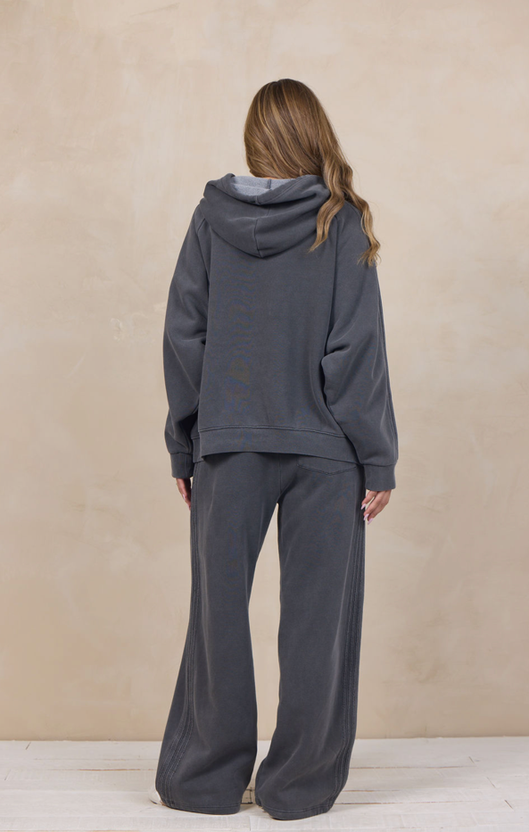Woman wearing a wide-leg sweatpant with an elastic waist.