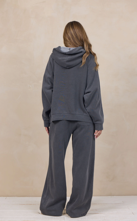 Woman wearing a wide-leg sweatpant with an elastic waist.