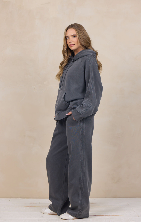 Woman wearing a wide-leg sweatpant with an elastic waist.