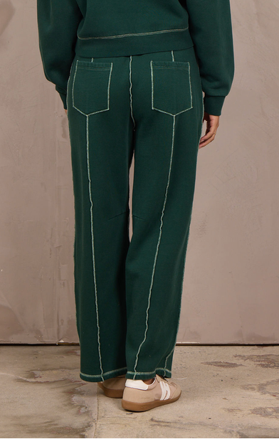 Woman wearing a wide-leg barbell pant with contrast stitching.