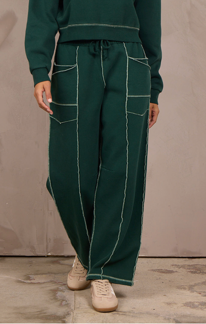 Woman wearing a wide-leg barbell pant with contrast stitching.