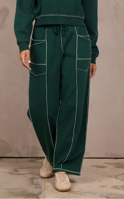 Woman wearing a wide-leg barbell pant with contrast stitching.