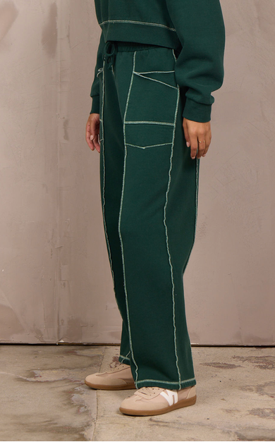 Woman wearing a wide-leg barbell pant with contrast stitching.