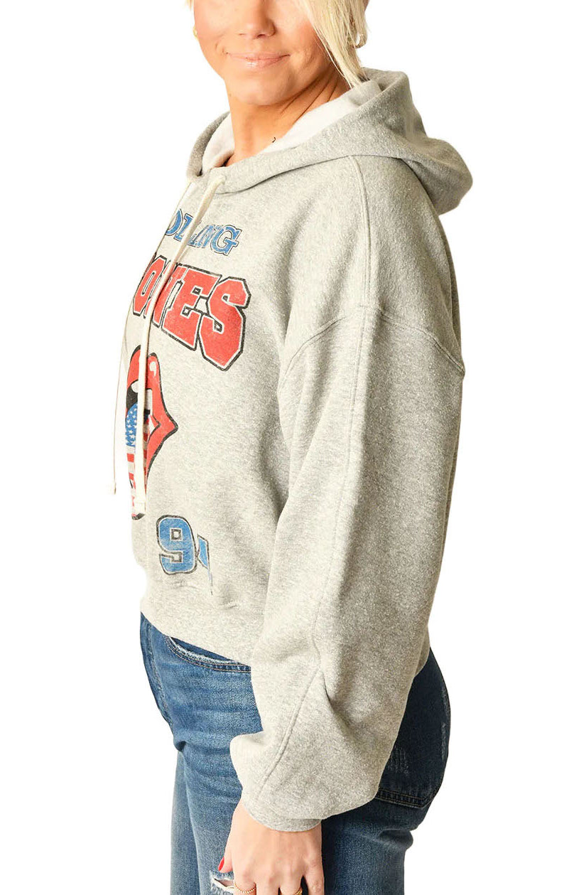 Rolling Stones Hoodie Heather Grey. Embrace the spirit of rock history with The Rolling Stones USA 1994 Hoodie. This hoodie provides cozy comfort while making a sustainable statement. It's a classic yet forward-thinking addition to any collection, offering warmth for the cool moments and a salute to timeless tunes.