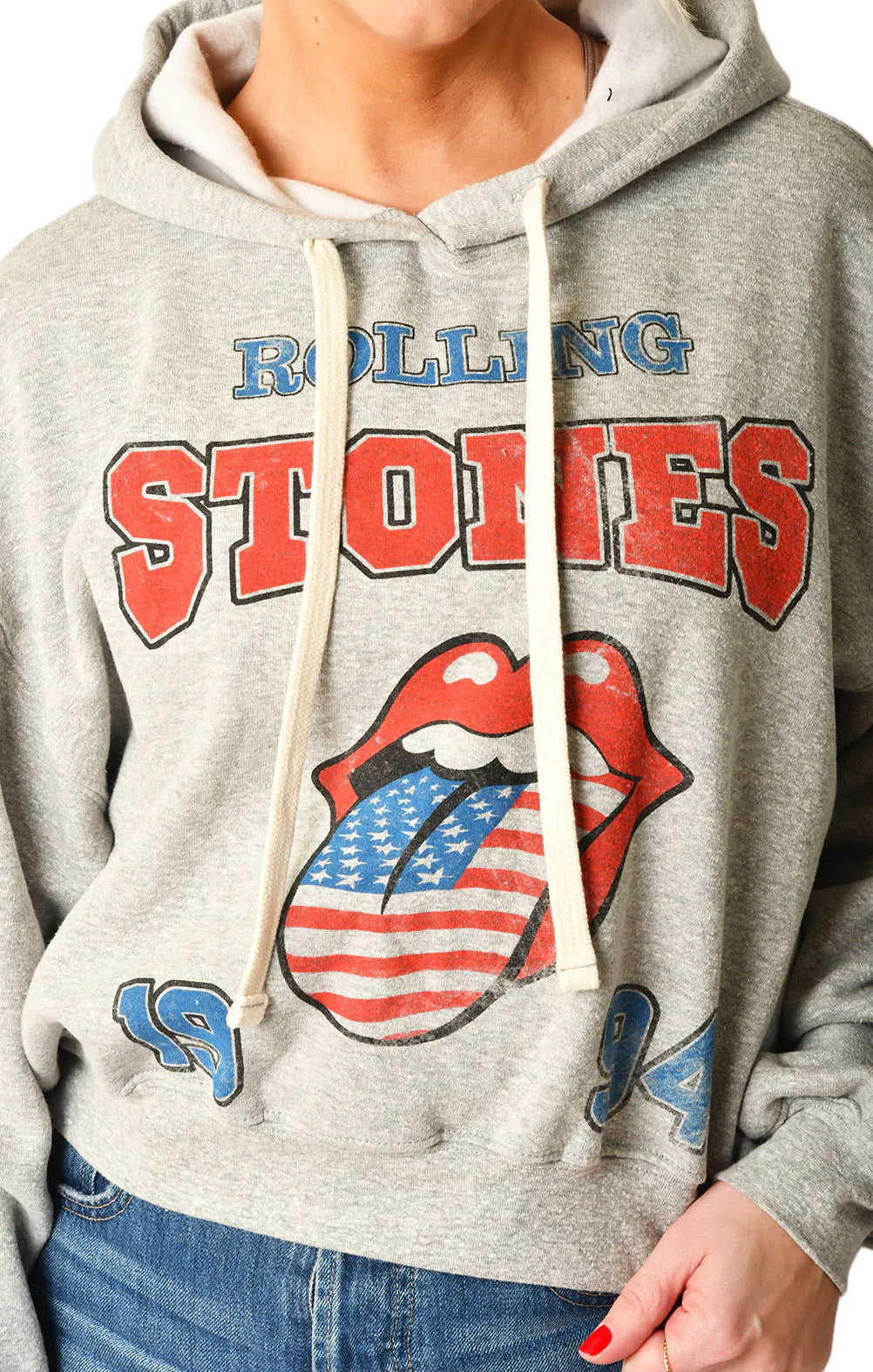 Rolling Stones Hoodie Heather Grey. Embrace the spirit of rock history with The Rolling Stones USA 1994 Hoodie. This hoodie provides cozy comfort while making a sustainable statement. It's a classic yet forward-thinking addition to any collection, offering warmth for the cool moments and a salute to timeless tunes.
