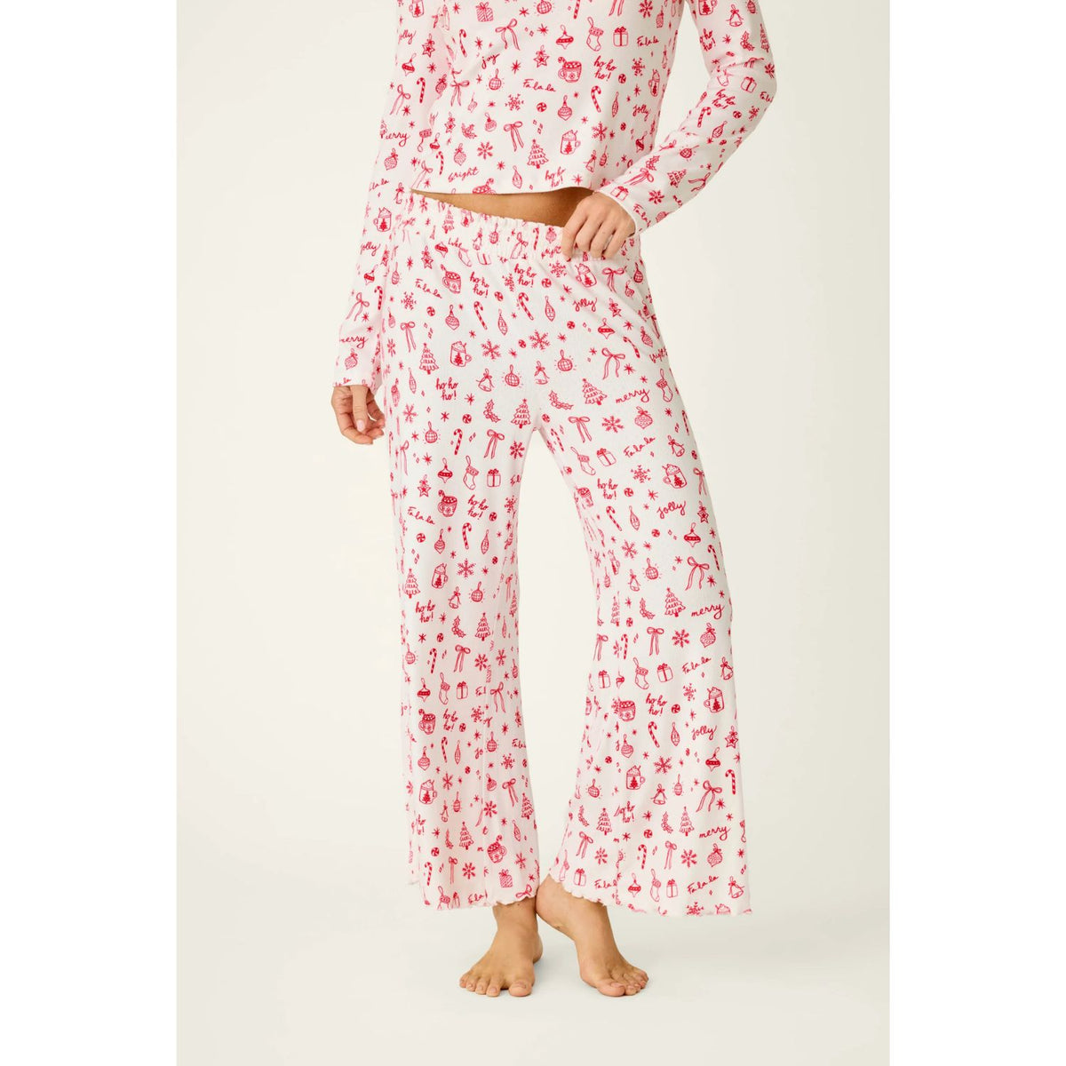 Ivory cropped pajama pants with red holiday print, smocked waistband, and open-leg silhouette
