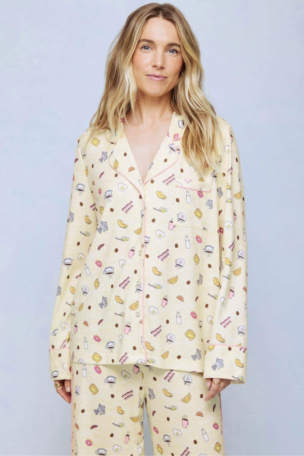 A cozy two-piece sleep set featuring brushed Pillowsoft fabric, a button-front top with contrast piping, and full-length drawstring pants for relaxing in comfort