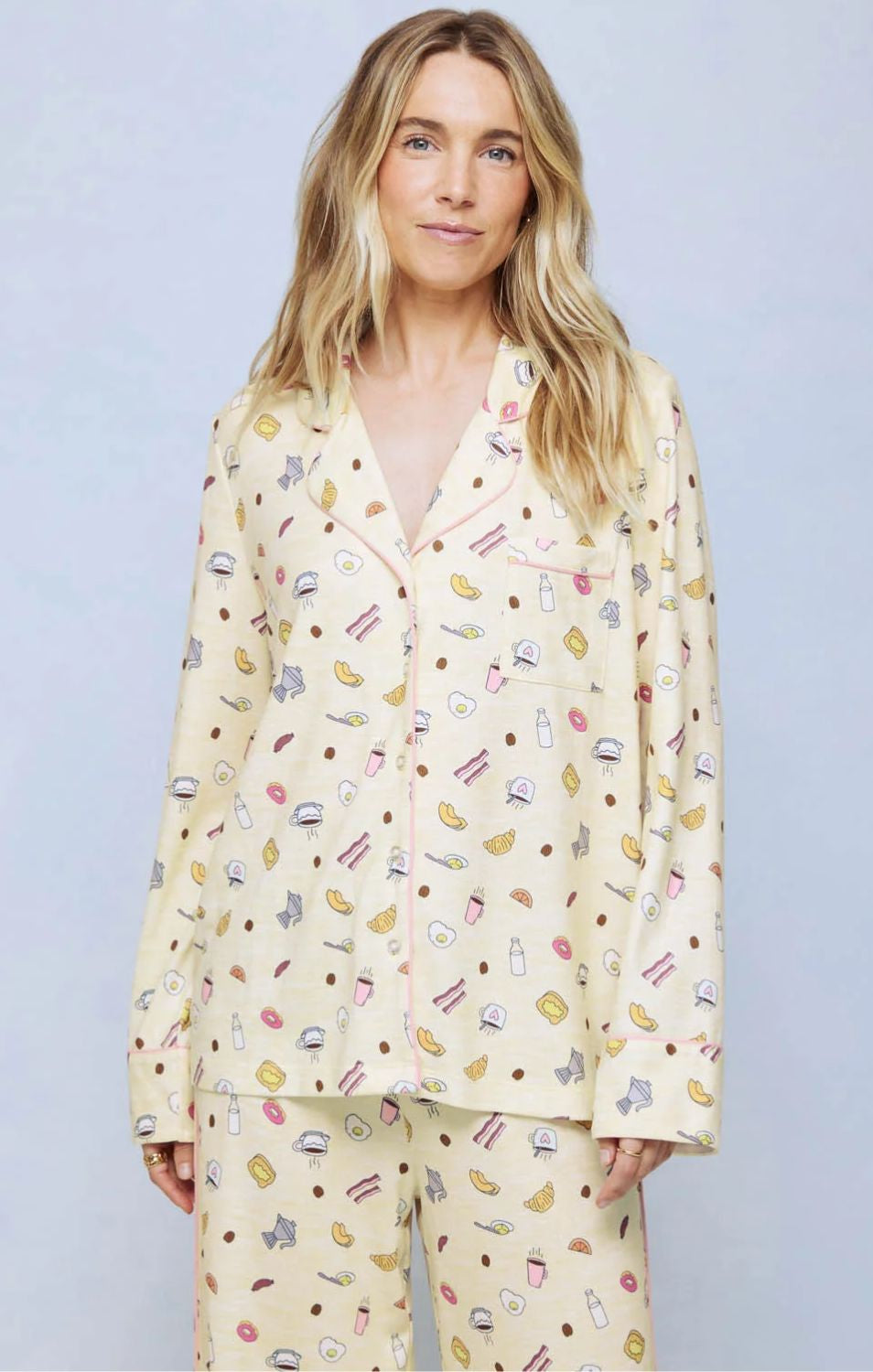 A cozy two-piece sleep set featuring brushed Pillowsoft fabric, a button-front top with contrast piping, and full-length drawstring pants for relaxing in comfort