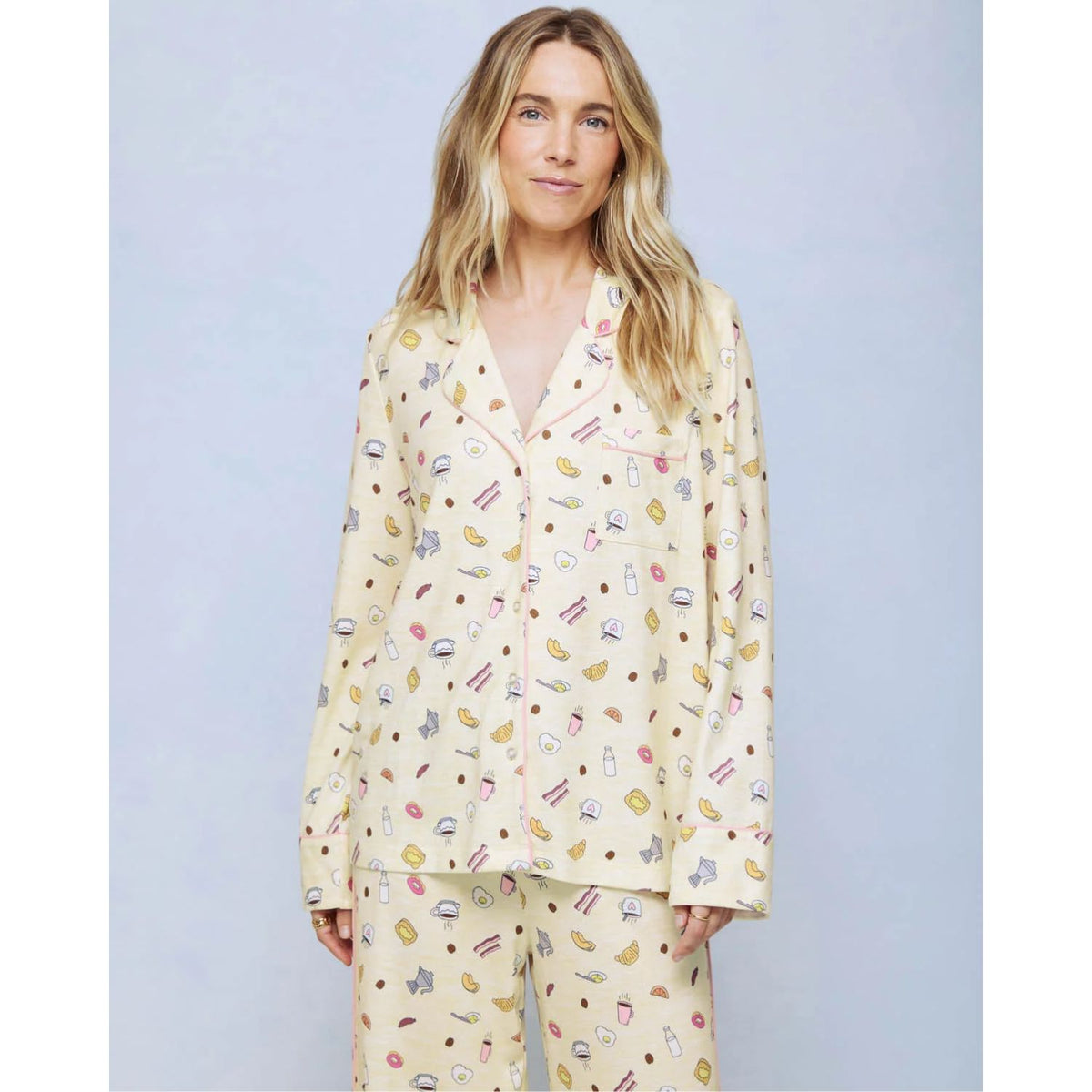 A cozy two-piece sleep set featuring brushed Pillowsoft fabric, a button-front top with contrast piping, and full-length drawstring pants for relaxing in comfort