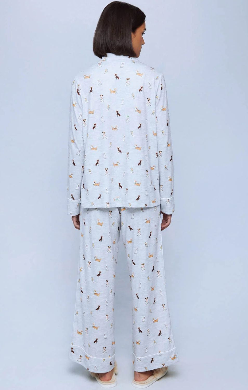 A cozy two-piece sleep set featuring brushed Pillowsoft fabric, a button-front top with contrast piping, and full-length drawstring pants for relaxing in comfort