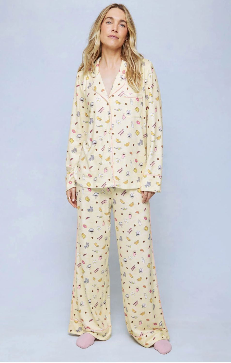 A cozy two-piece sleep set featuring brushed Pillowsoft fabric, a button-front top with contrast piping, and full-length drawstring pants for relaxing in comfort