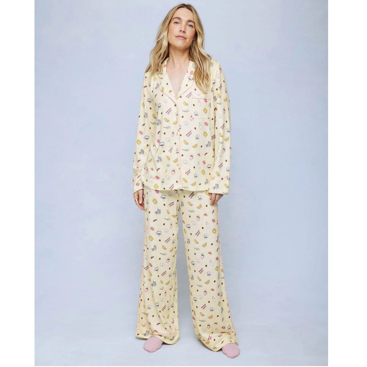 A cozy two-piece sleep set featuring brushed Pillowsoft fabric, a button-front top with contrast piping, and full-length drawstring pants for relaxing in comfort