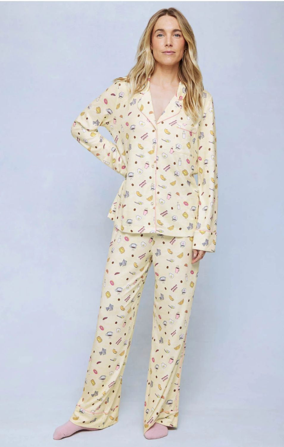 A cozy two-piece sleep set featuring brushed Pillowsoft fabric, a button-front top with contrast piping, and full-length drawstring pants for relaxing in comfort
