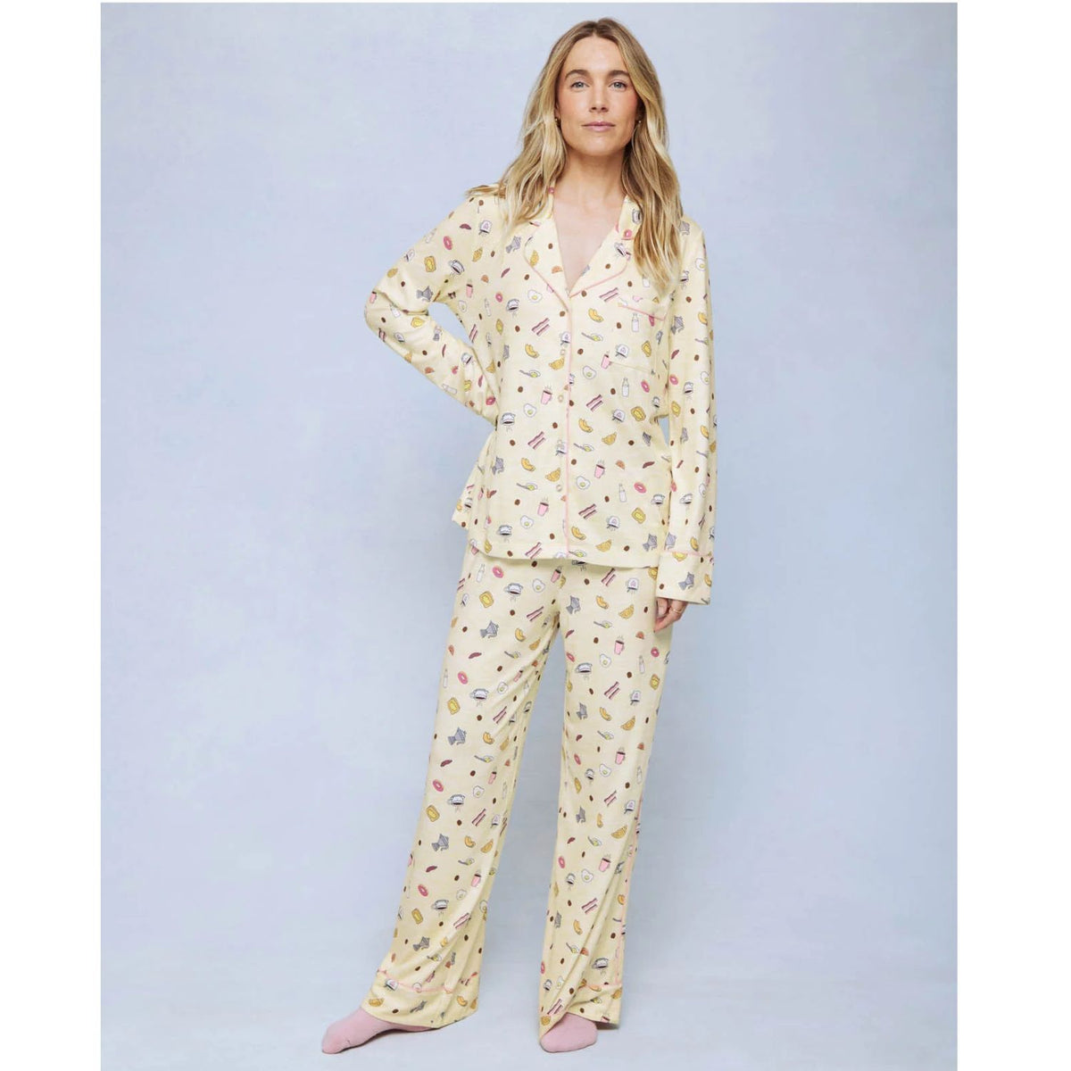 A cozy two-piece sleep set featuring brushed Pillowsoft fabric, a button-front top with contrast piping, and full-length drawstring pants for relaxing in comfort