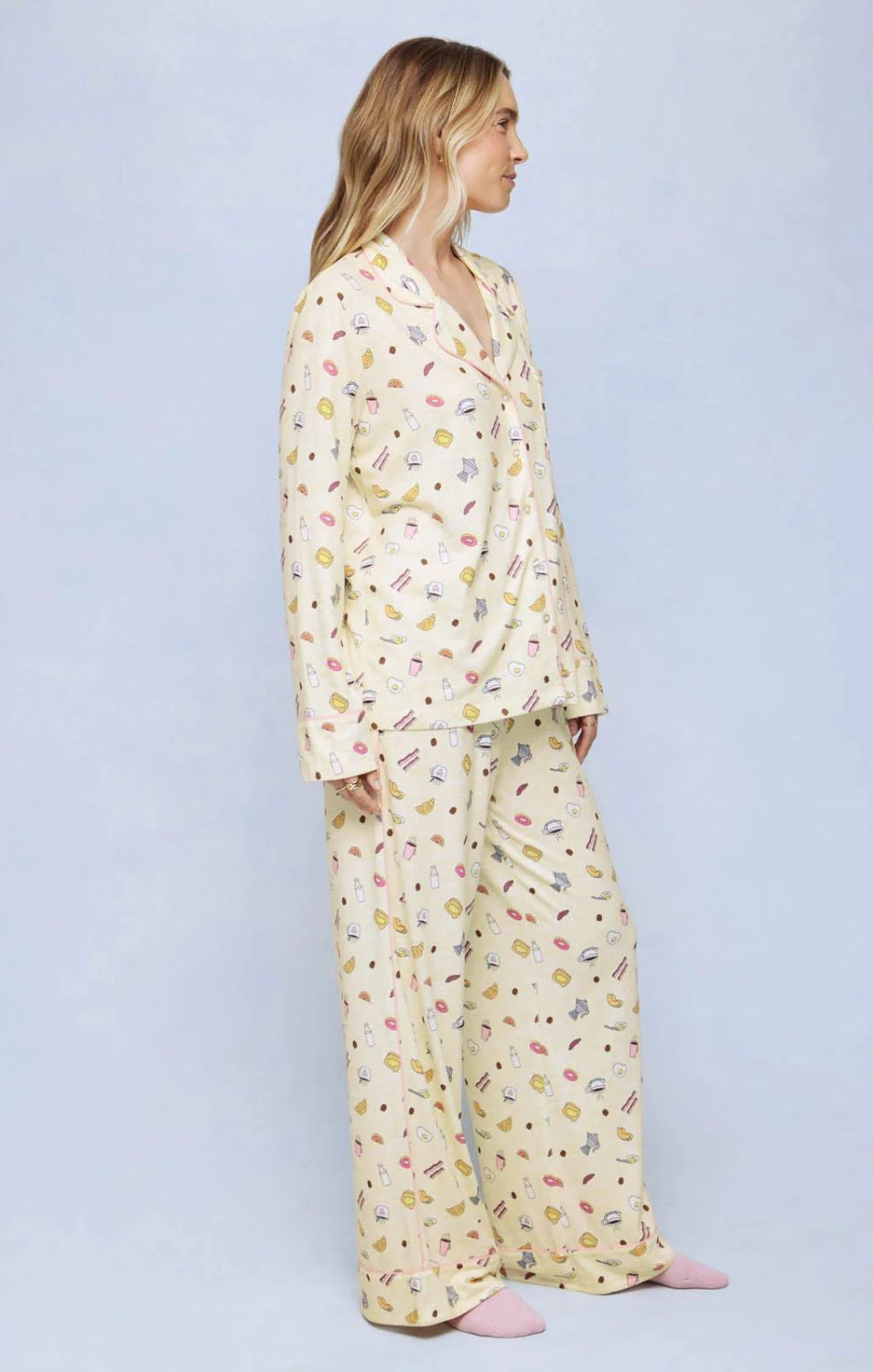 A cozy two-piece sleep set featuring brushed Pillowsoft fabric, a button-front top with contrast piping, and full-length drawstring pants for relaxing in comfort