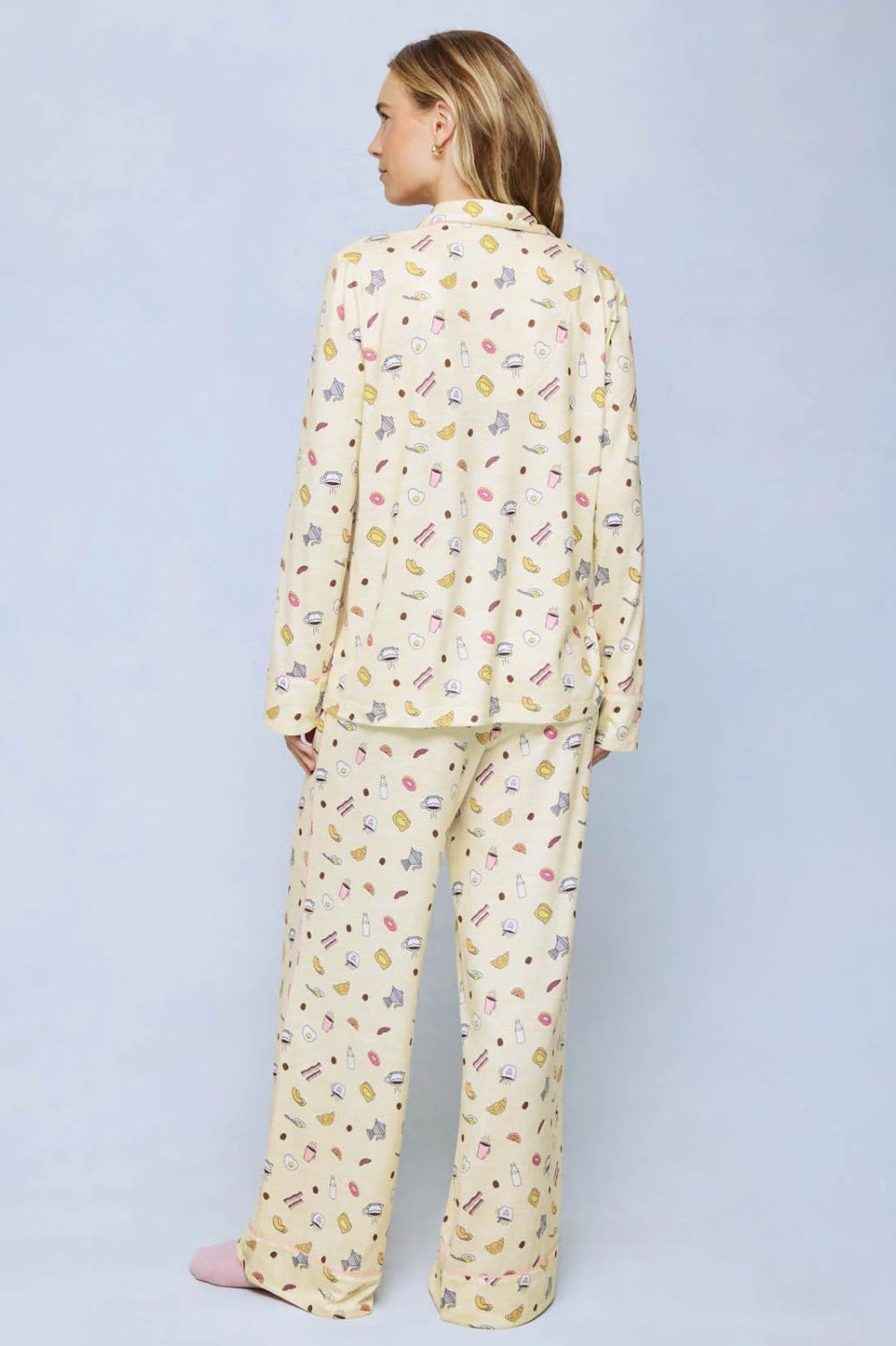 A cozy two-piece sleep set featuring brushed Pillowsoft fabric, a button-front top with contrast piping, and full-length drawstring pants for relaxing in comfort