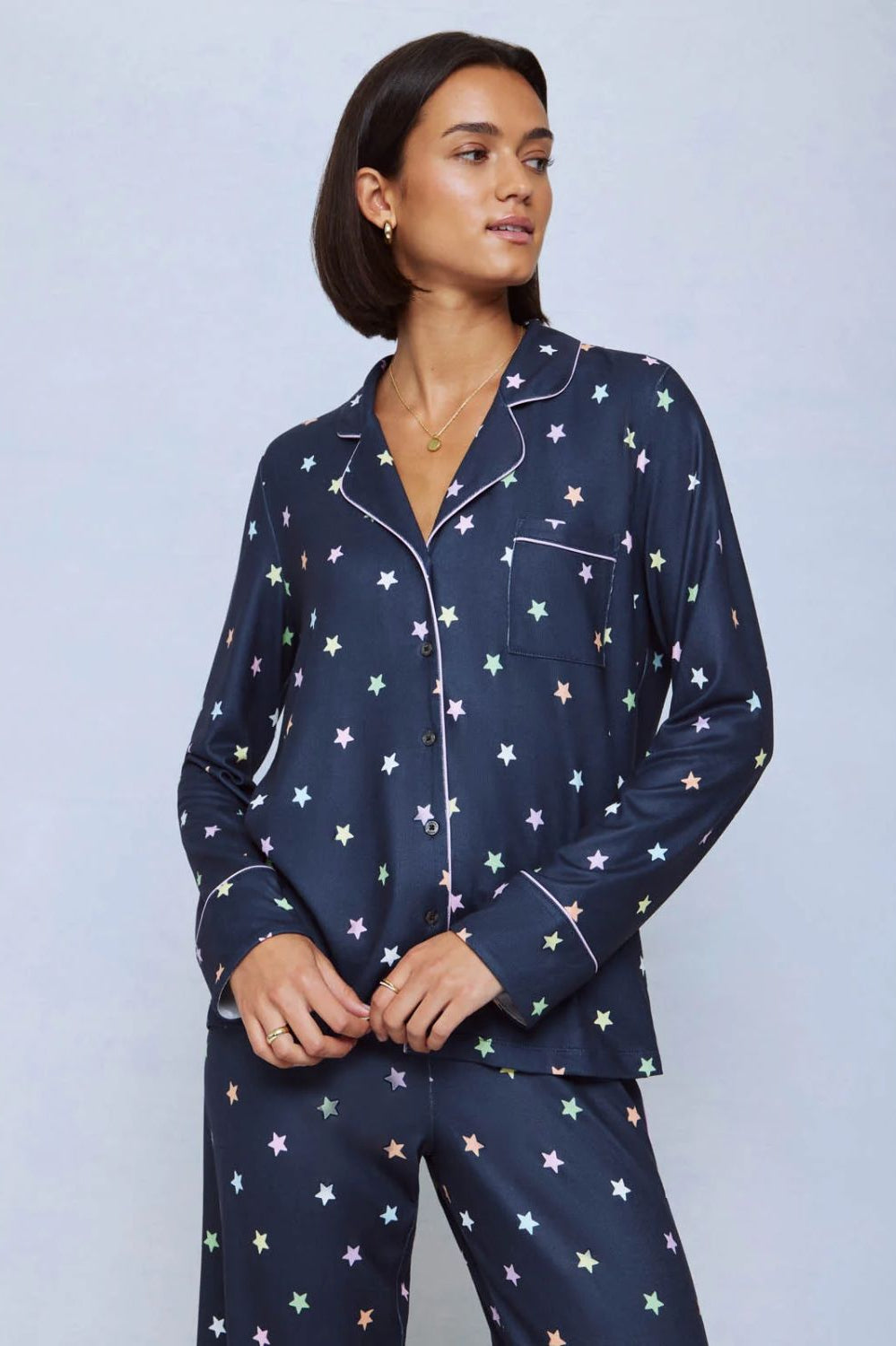 A cozy two-piece sleep set featuring brushed Pillowsoft fabric, a button-front top with contrast piping, and full-length drawstring pants for relaxing in comfort