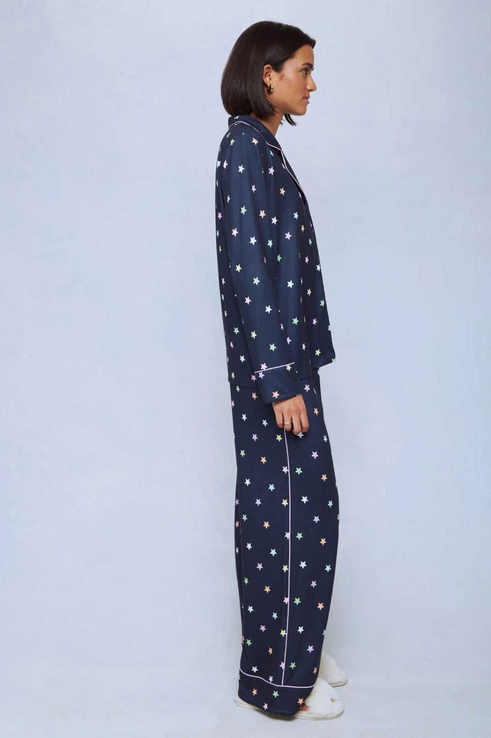 A cozy two-piece sleep set featuring brushed Pillowsoft fabric, a button-front top with contrast piping, and full-length drawstring pants for relaxing in comfort