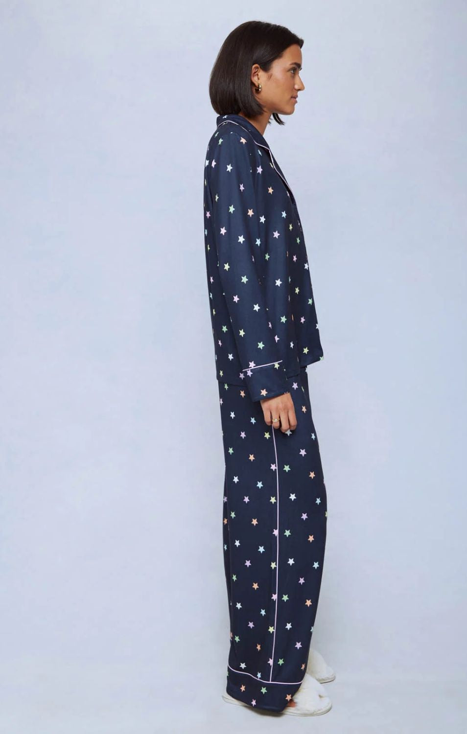 A cozy two-piece sleep set featuring brushed Pillowsoft fabric, a button-front top with contrast piping, and full-length drawstring pants for relaxing in comfort