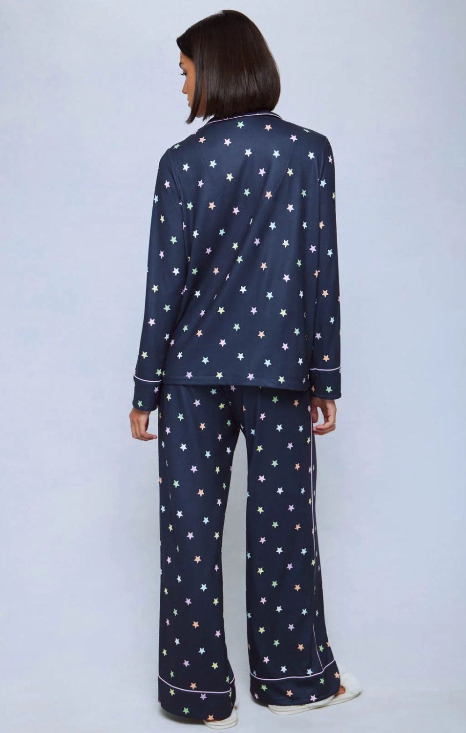 A cozy two-piece sleep set featuring brushed Pillowsoft fabric, a button-front top with contrast piping, and full-length drawstring pants for relaxing in comfort