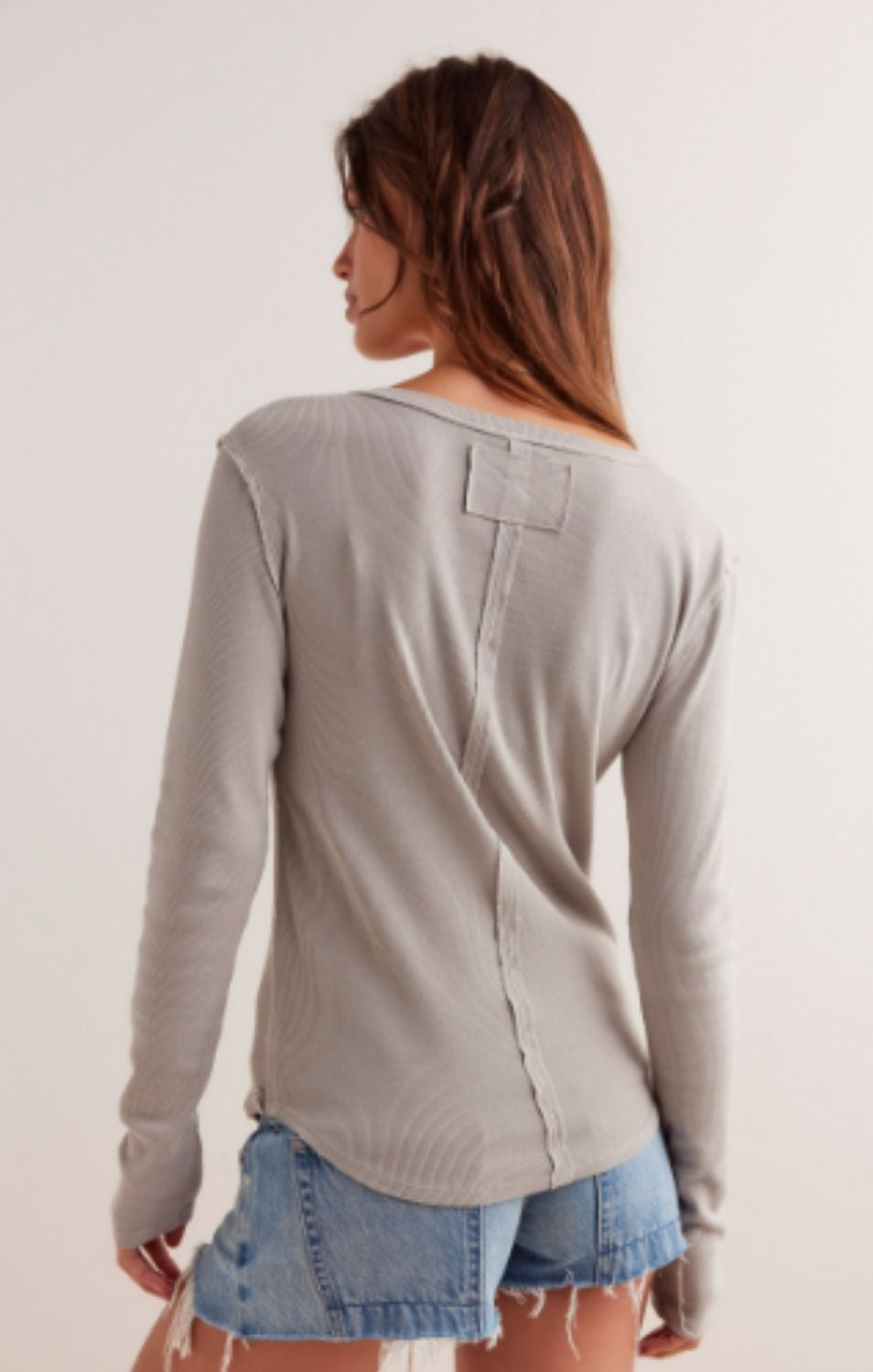Free People Jamie Henley long-sleeve knit top featuring a slim fit, defined seams, and button-front detailing