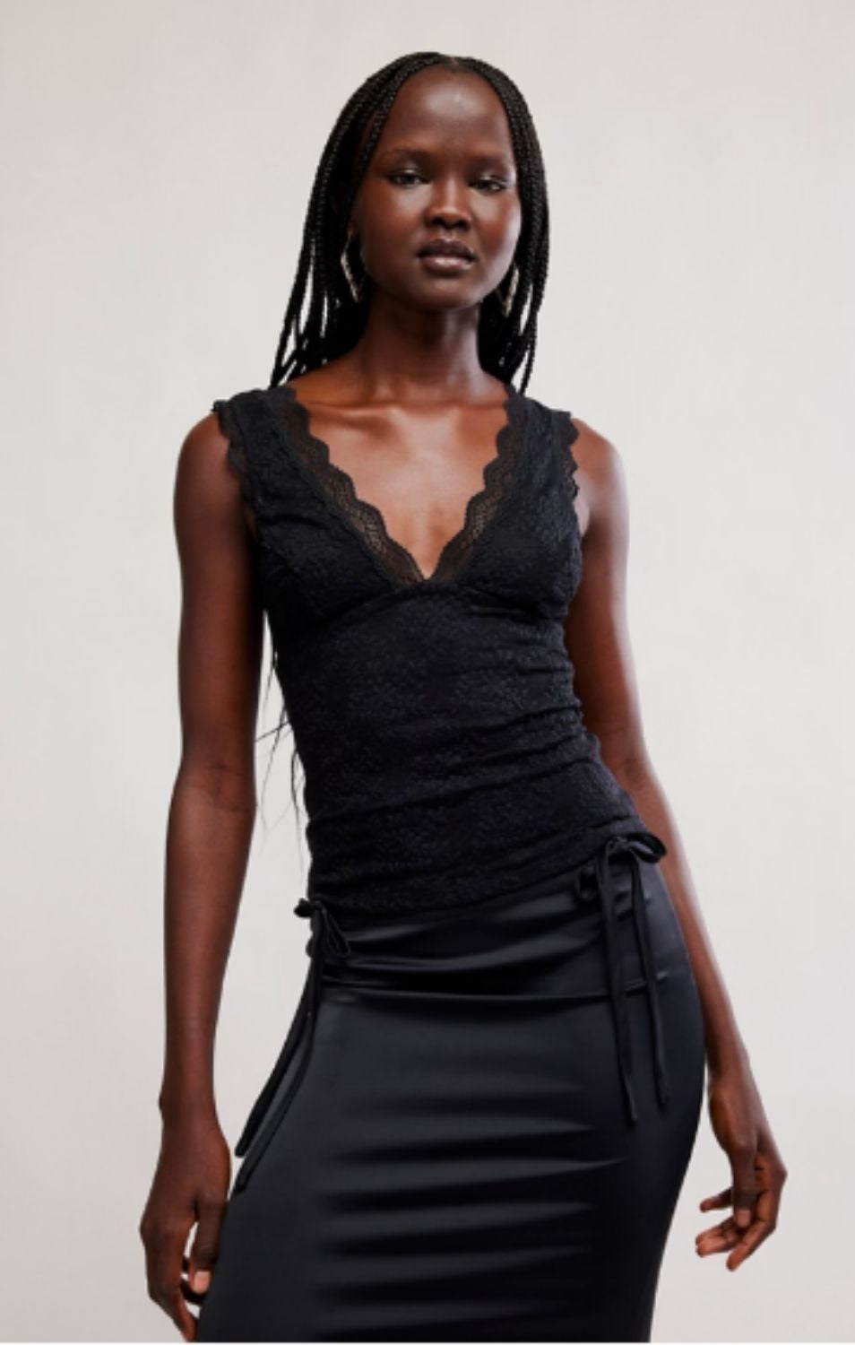 Women's lace tank top featuring a V-neckline, scalloped trim, and feminine open-back detailing