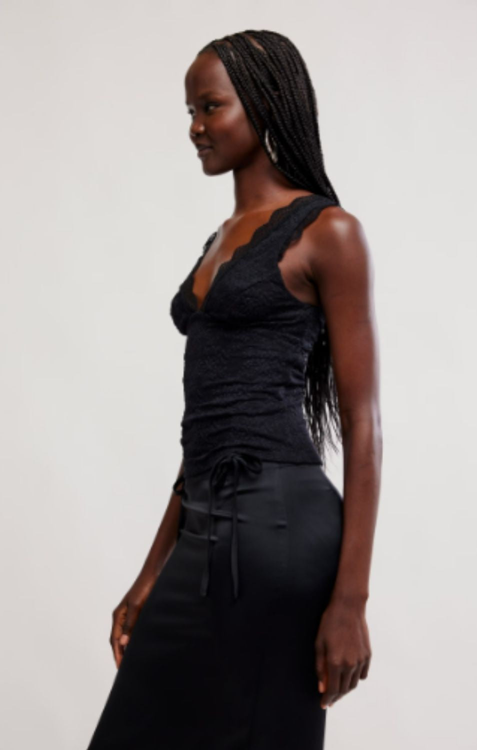 Women's lace tank top featuring a V-neckline, scalloped trim, and feminine open-back detailing