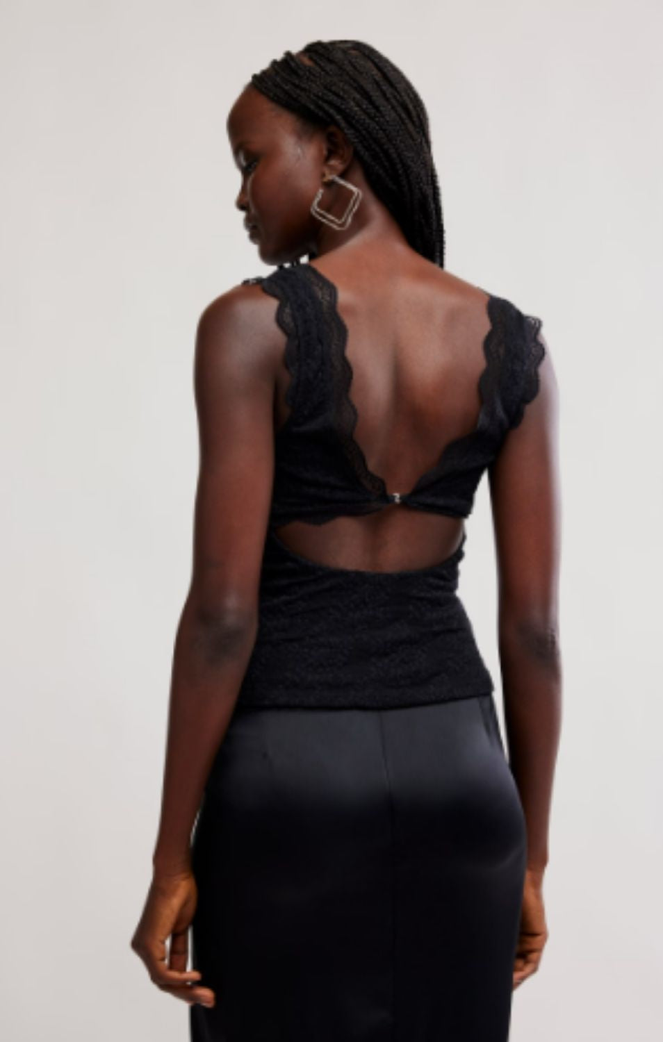 Women's lace tank top featuring a V-neckline, scalloped trim, and feminine open-back detailing