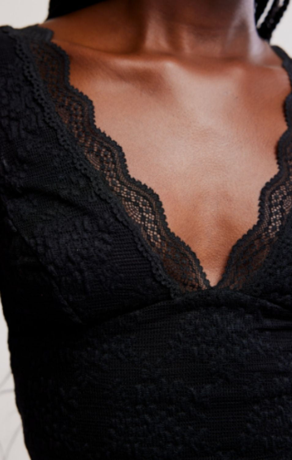 Women's lace tank top featuring a V-neckline, scalloped trim, and feminine open-back detailing