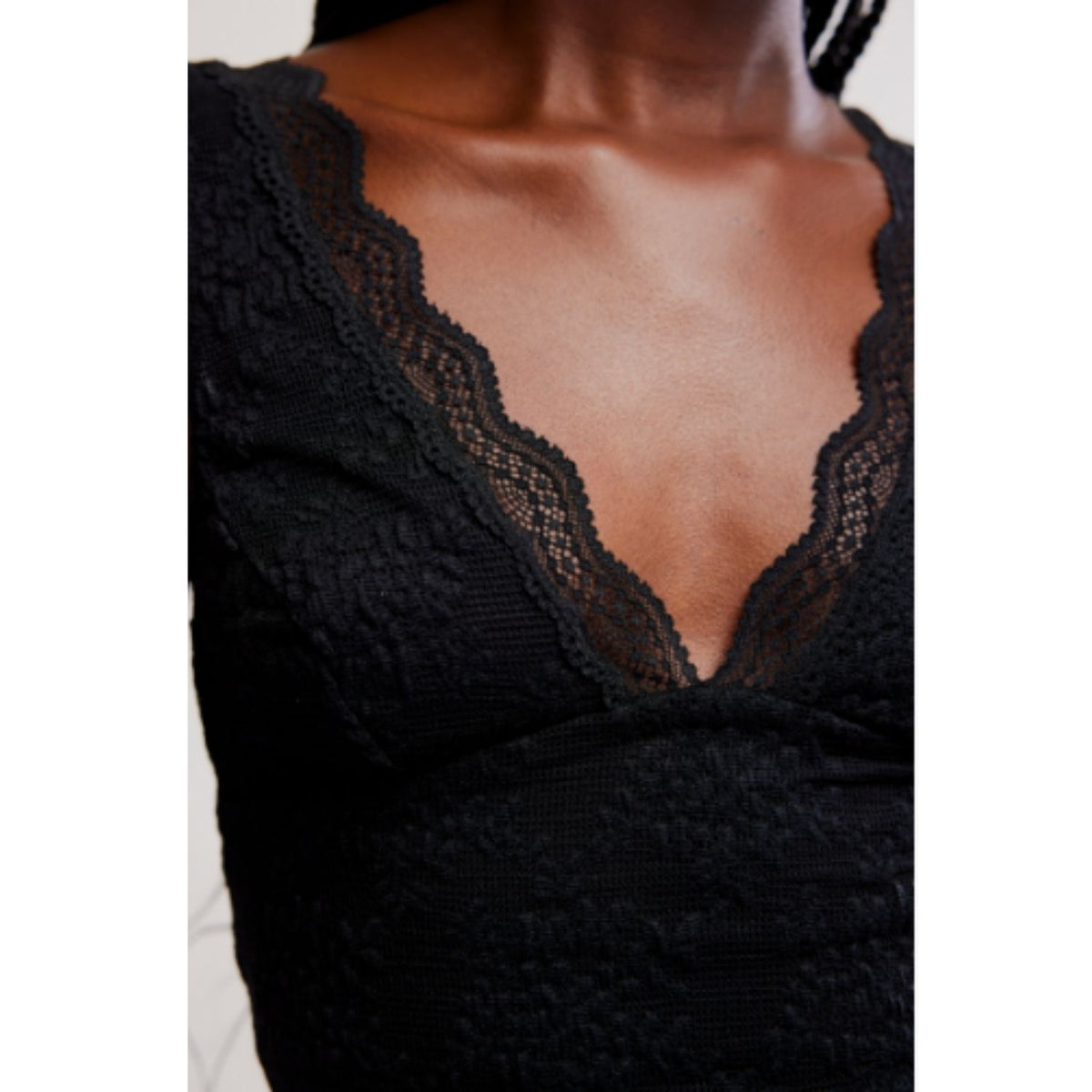 Women's lace tank top featuring a V-neckline, scalloped trim, and feminine open-back detailing