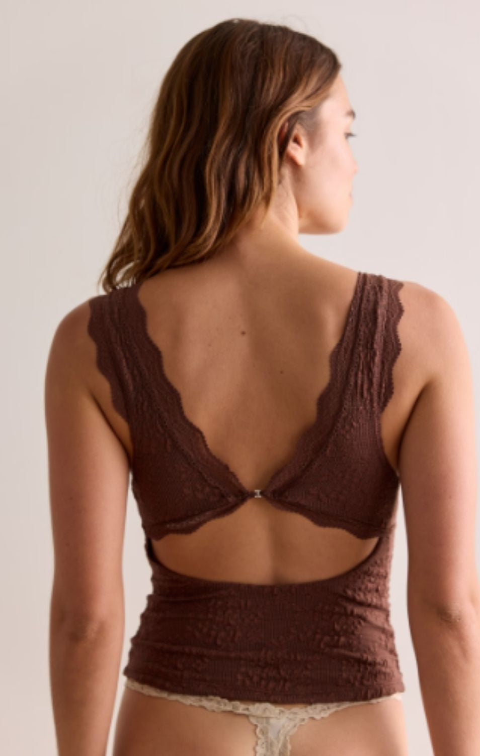 Women's lace tank top featuring a V-neckline, scalloped trim, and feminine open-back detailing