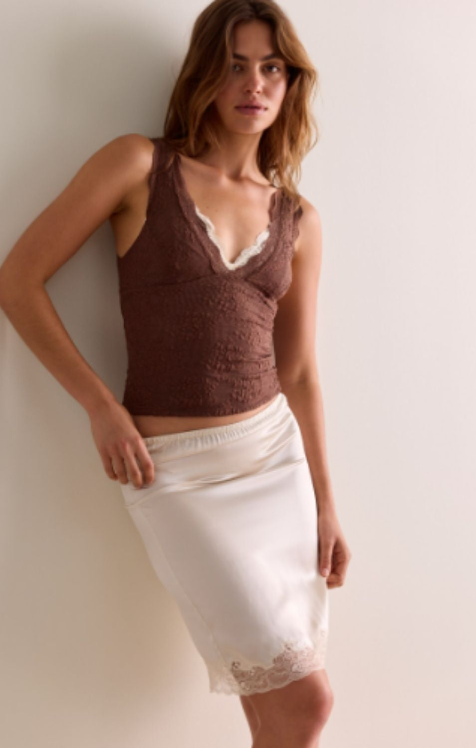 Women's lace tank top featuring a V-neckline, scalloped trim, and feminine open-back detailing