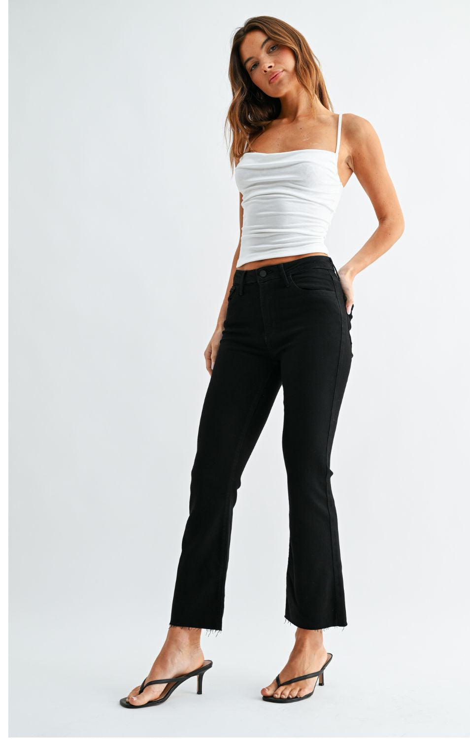 High-Rise Cropped Demi Flare Jeans feature a slim fit through the hips and thighs with a gently flared leg. The cropped silhouette and comfortable stretch offer a flattering, modern denim look