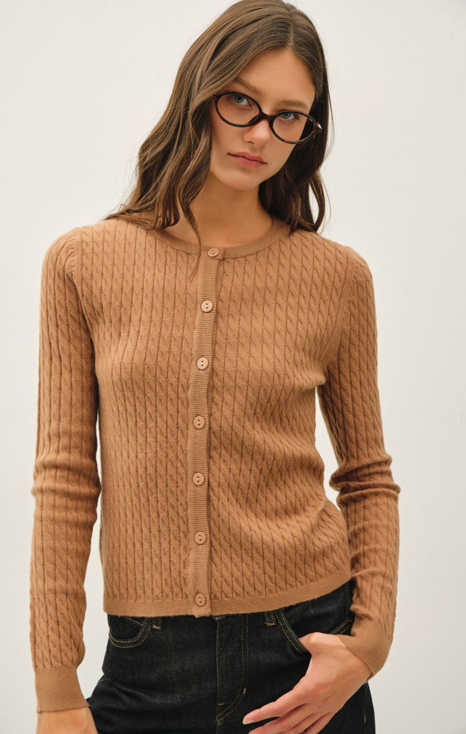 Women's fine cable knit cardigan with a crew neckline, button-up front, long sleeves, and slim-fit silhouette