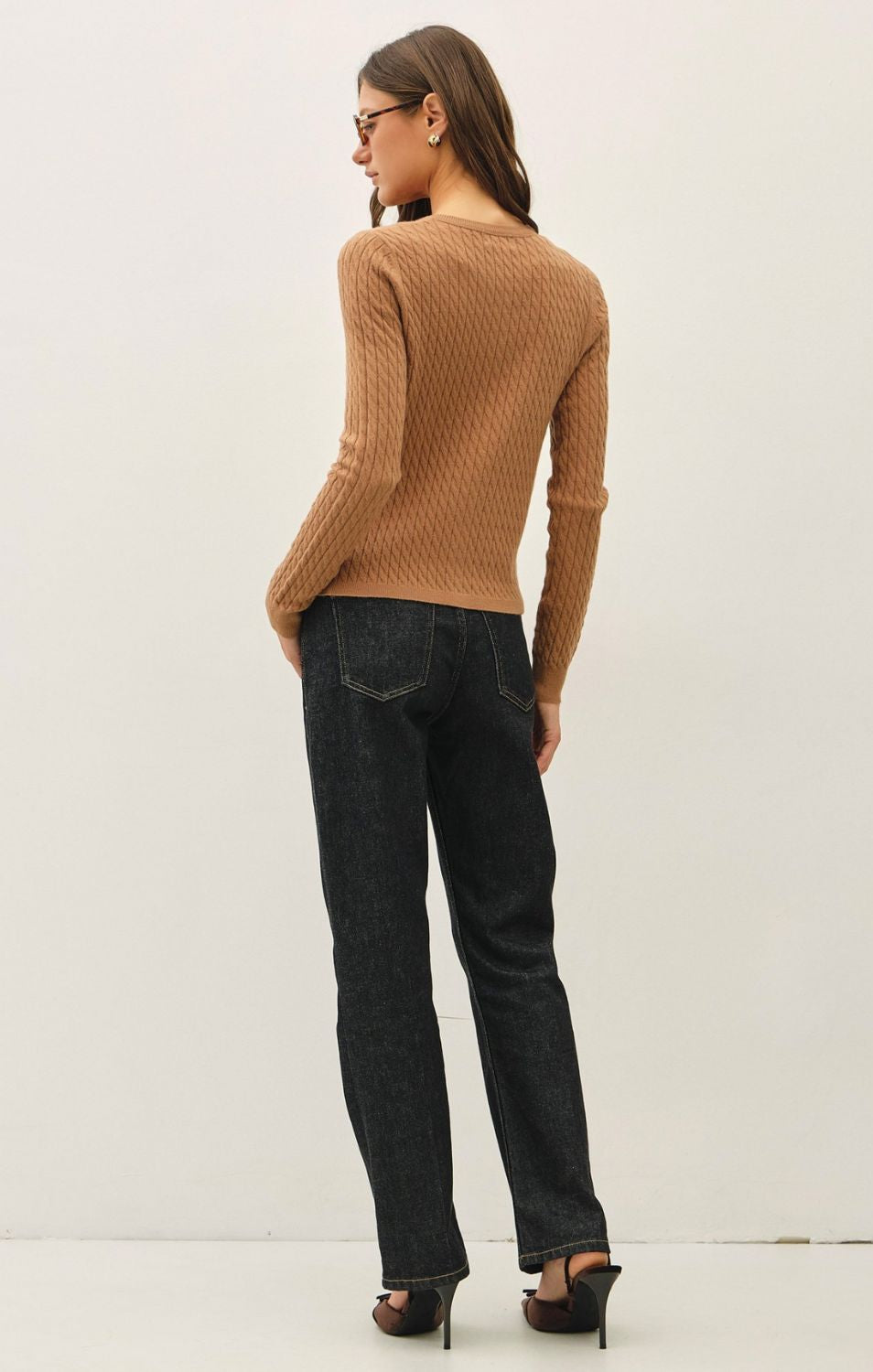 Women's fine cable knit cardigan with a crew neckline, button-up front, long sleeves, and slim-fit silhouette