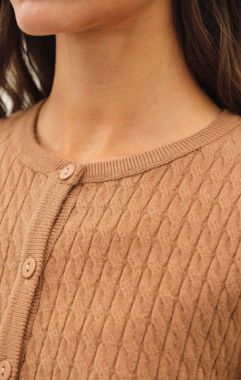 Women's fine cable knit cardigan with a crew neckline, button-up front, long sleeves, and slim-fit silhouette