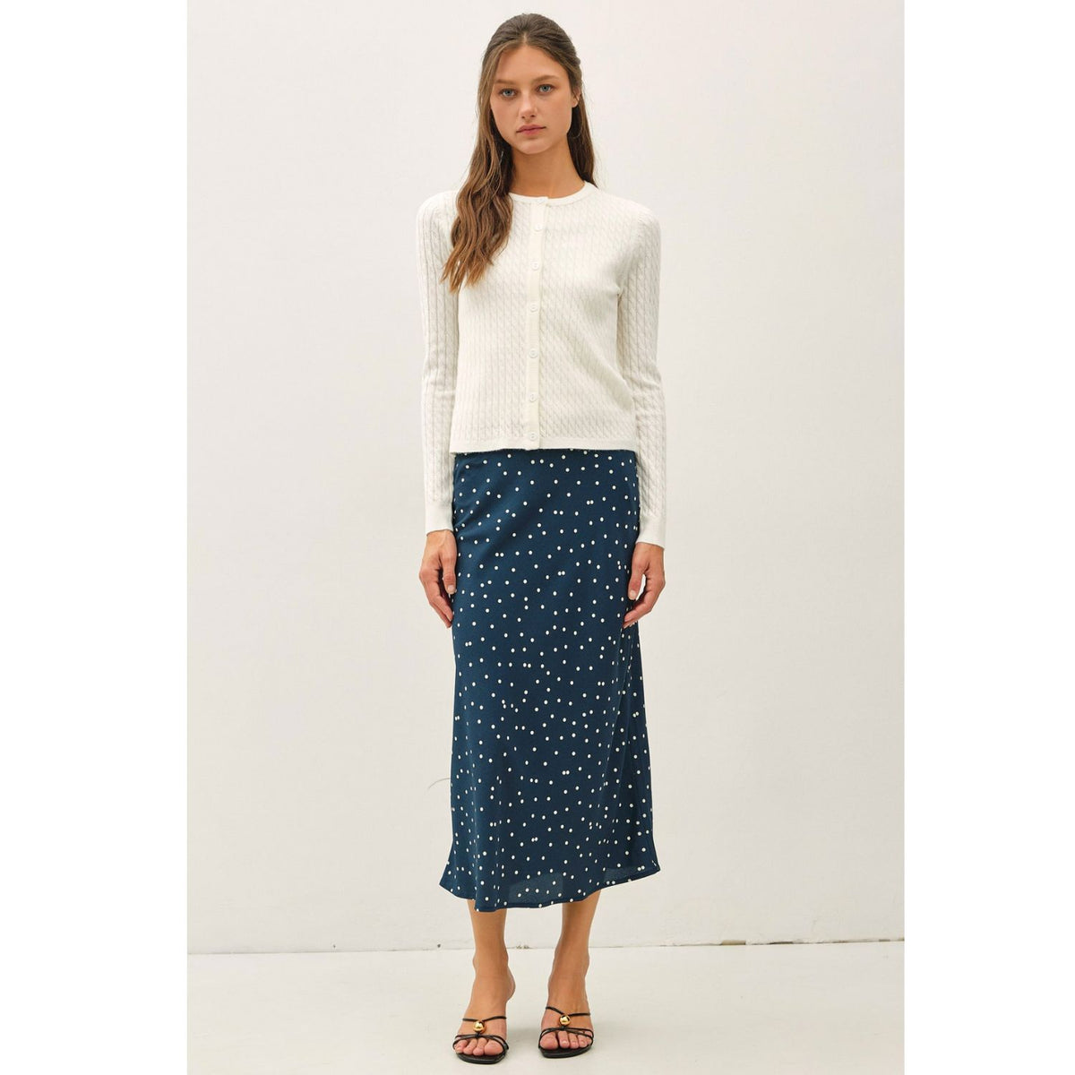 Women's fine cable knit cardigan with a crew neckline, button-up front, long sleeves, and slim-fit silhouette