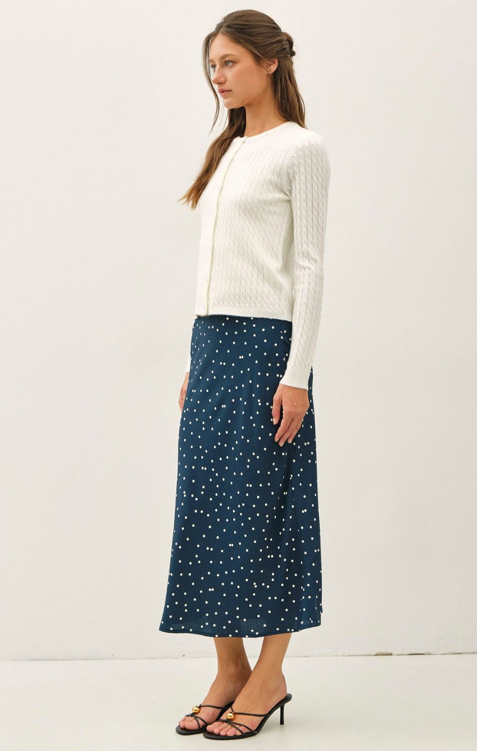 Women's fine cable knit cardigan with a crew neckline, button-up front, long sleeves, and slim-fit silhouette