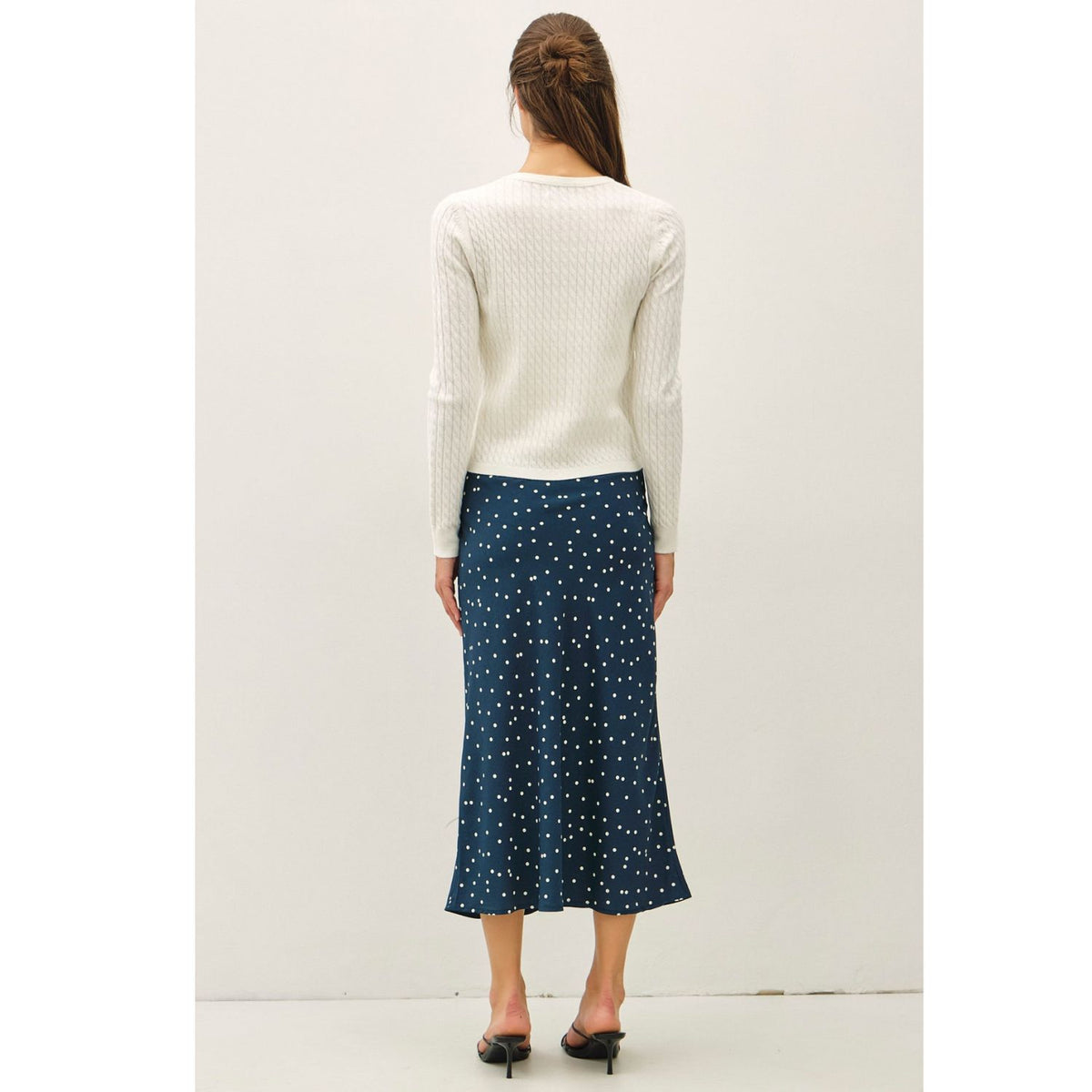 Women's fine cable knit cardigan with a crew neckline, button-up front, long sleeves, and slim-fit silhouette
