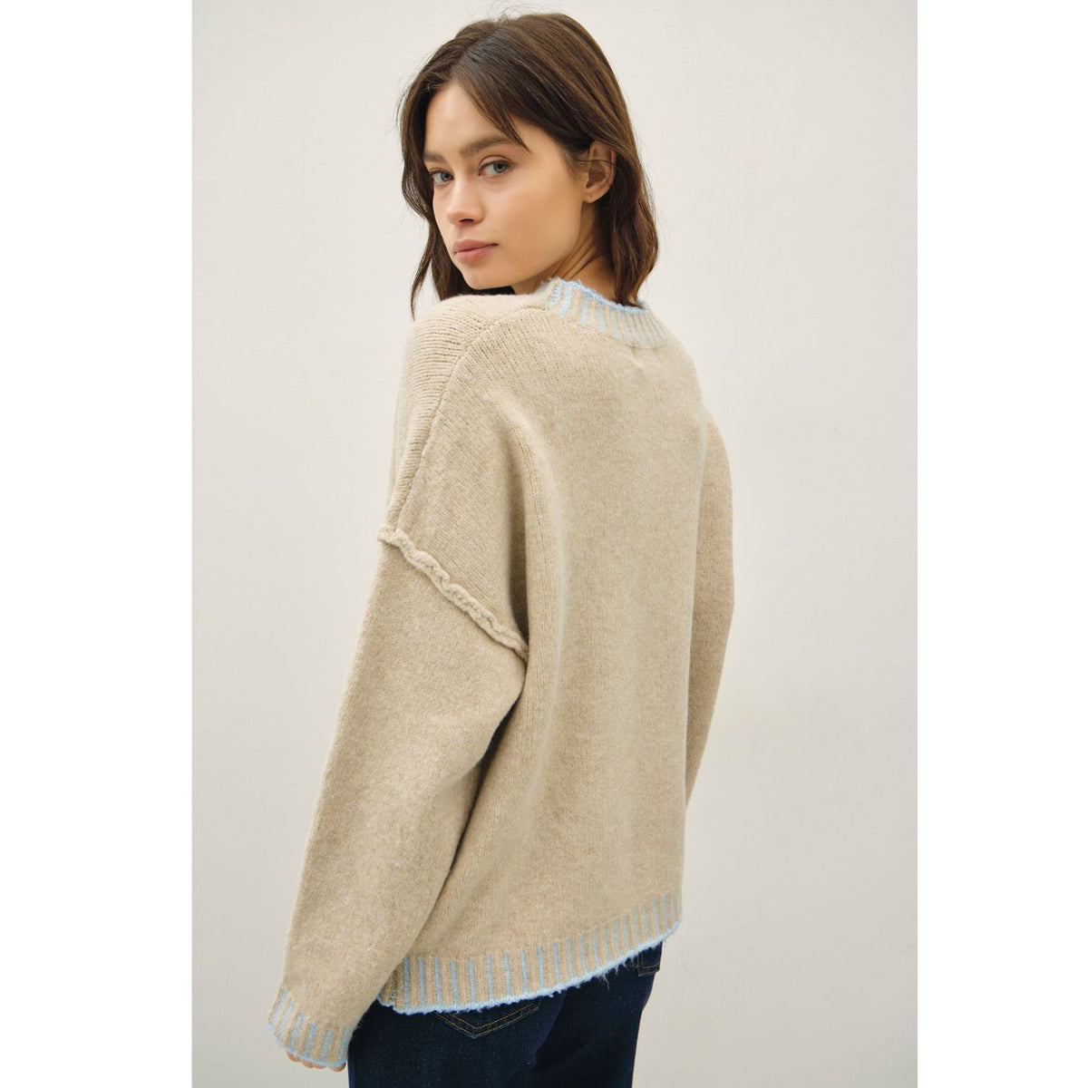 Women's oversized mock neck sweater with dropped shoulders, contrast stitching accents, and a relaxed fit