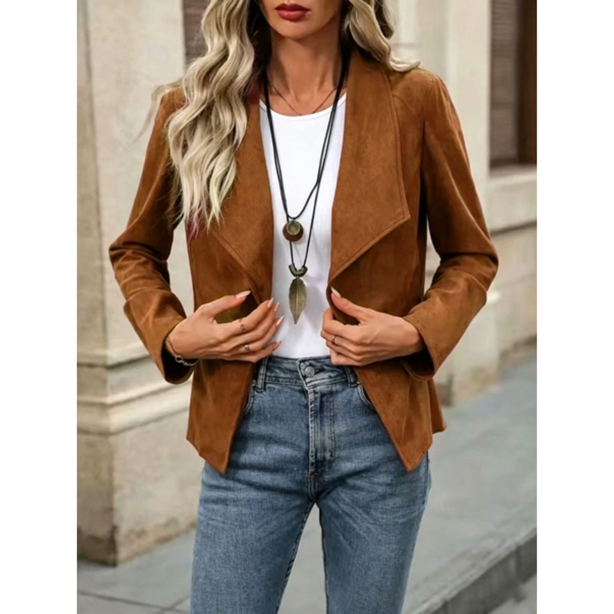 Faux suede jacket with an open front, draped lapel, and long sleeves.