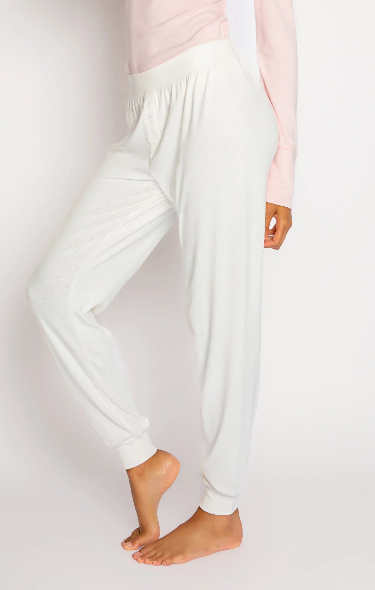PJ Salvage Pointelle Hearts Pant Ivory. Rest easy in these brushed pajama pants, especially in an incredibly soft pointelle pattern, featuring mini hearts and banded cuffs with mini faux button fly.